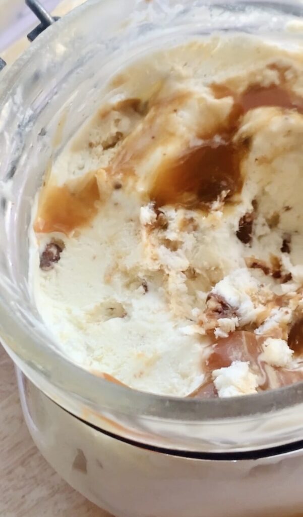 Eis mit Karamellsauce und Schokostückchen.